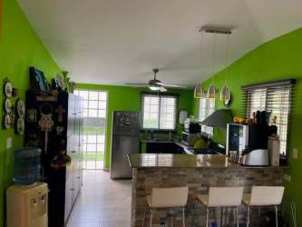 Ranch style house with gated entrance and lush greenery Las Lajas Panama