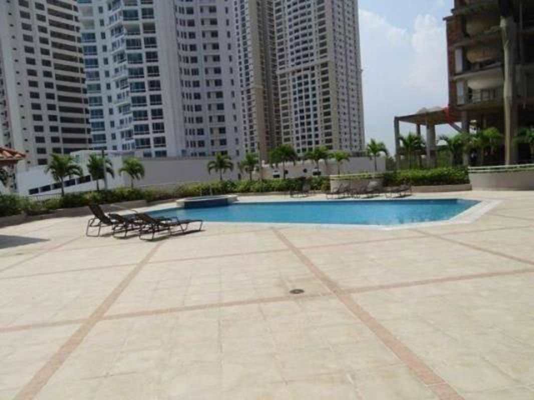 Modern high-rise condo tower with balconies in PH Panama Bay Costa del Este under blue sky