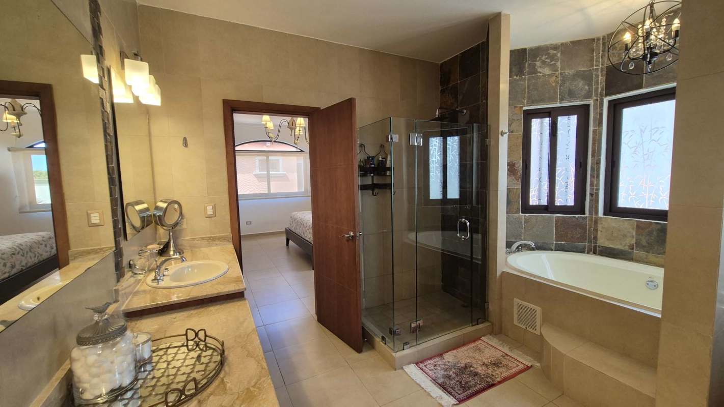 Contemporary bathroom with double sink vanity, bathtub and glass shower in El Doral Costa Sur Panama City