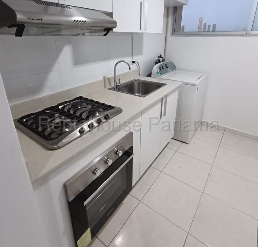 Modern kitchen with white cabinetry, stove, oven, window in PH Llano Bonito Don Bosco Panama