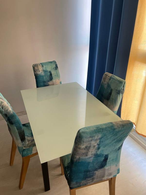 Furnished bedroom with yellow tufted bed and large window in PH Bella Natura Los Andes