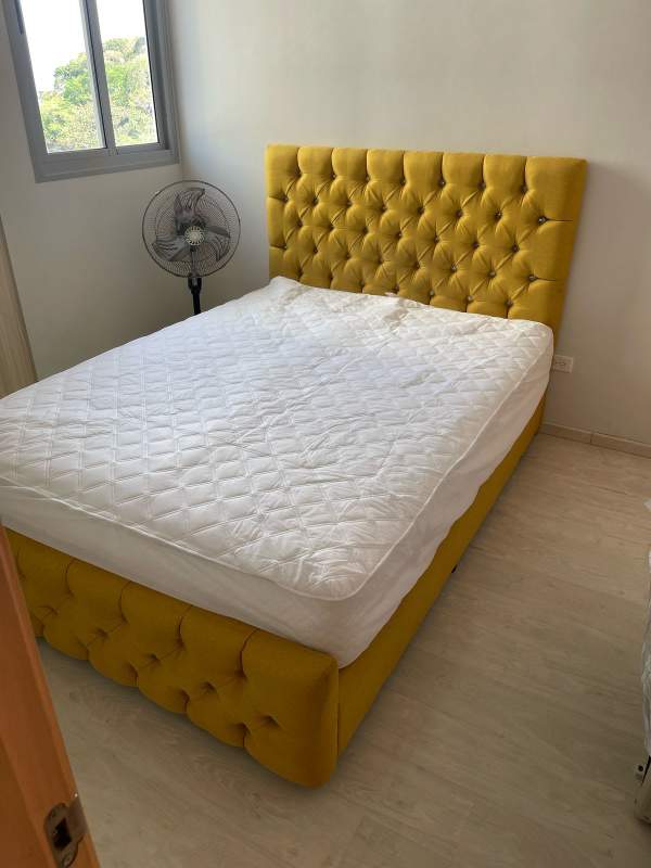 Dining area with glass-top table, colorful chairs, large curtains in PH Bella Natura Los Andes Panama