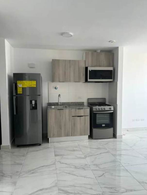 Kitchen with granite countertop, built-in appliances in The Gray Panama