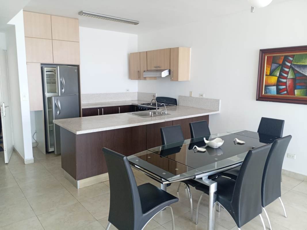 Dining area with modern kitchen stainless steel appliances in PH H2O Panama City