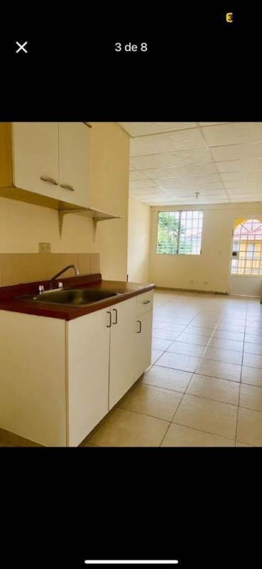 Open plan kitchen with tiled floors and window in Don Bosco apartment Panama