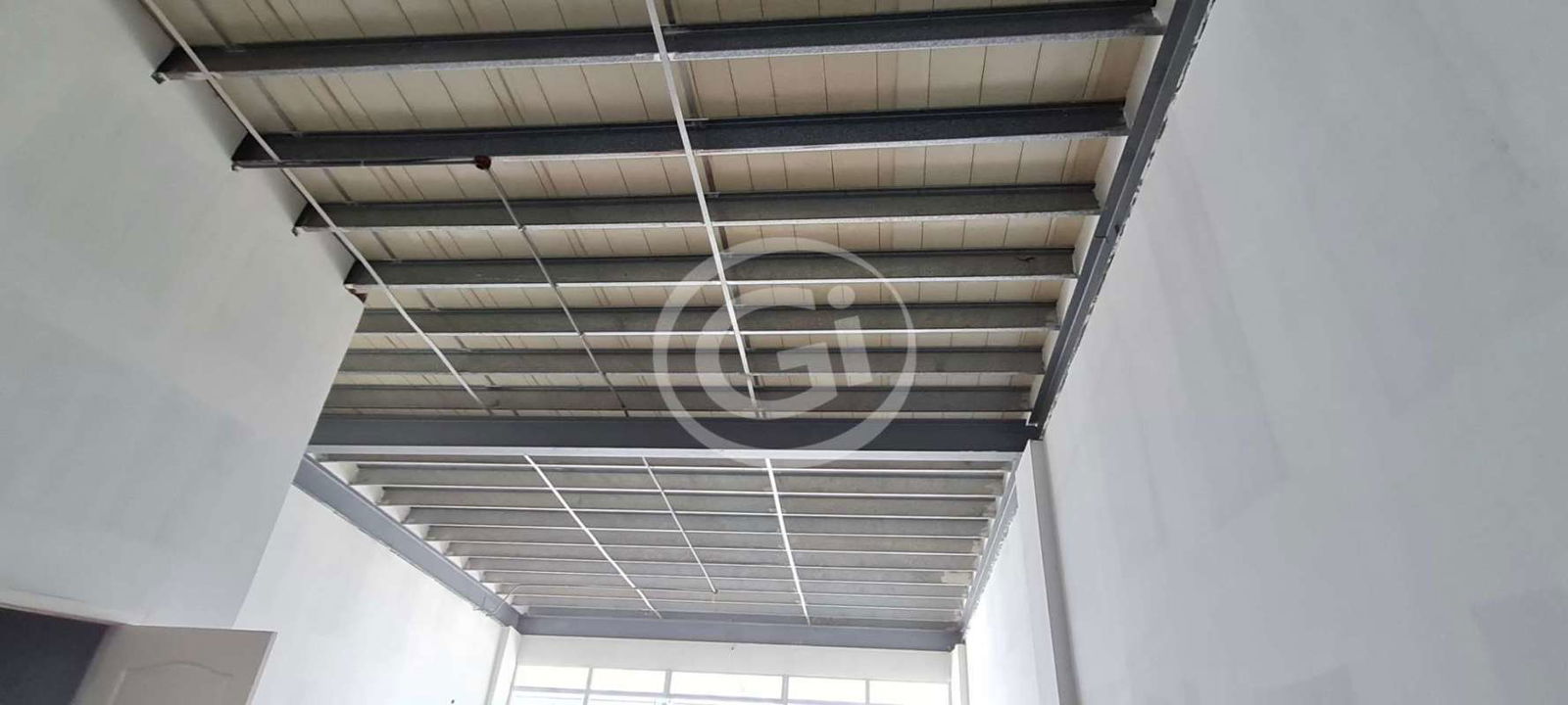 Warehouse-style double height space with exposed ceiling and concrete floors in Panama shopping plaza