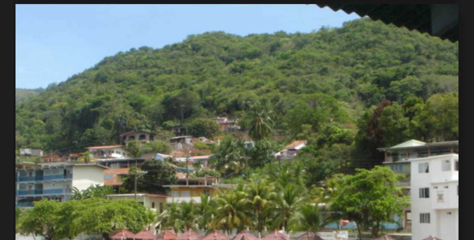 Tropical hillside village Isla Taboga with residential homes, lush vegetation, panoramic ocean view