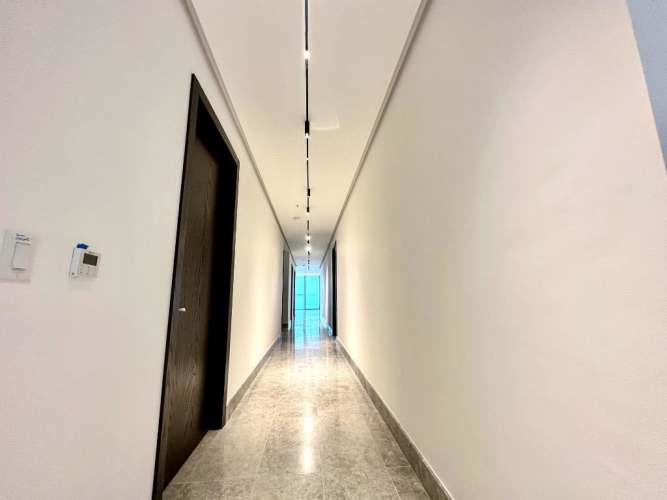Modern living room with marble floor and panoramic Pacific Ocean views through large windows at PH Yacht Club Tower Punta Paitilla
