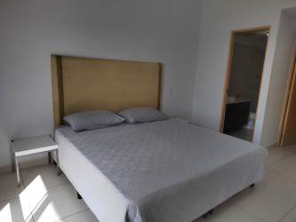 Outdoor swimming pool surrounded by gardens at PH River Valley Panama Pacifico