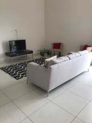 Open plan living and dining space with balcony access in PH River Valley Panama Pacifico