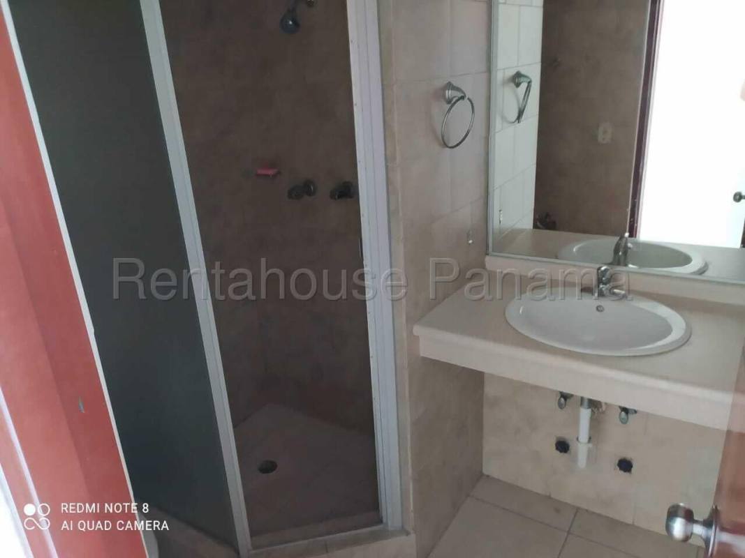 Apartment bathroom with glass door shower and sink counter PH Green Park Condado