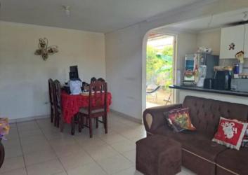 Traditional kitchen with white cabinetry window and stove connection in house La Chorrera
