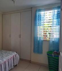 Second bedroom blue curtain window wardrobe La Chorrera affordable home