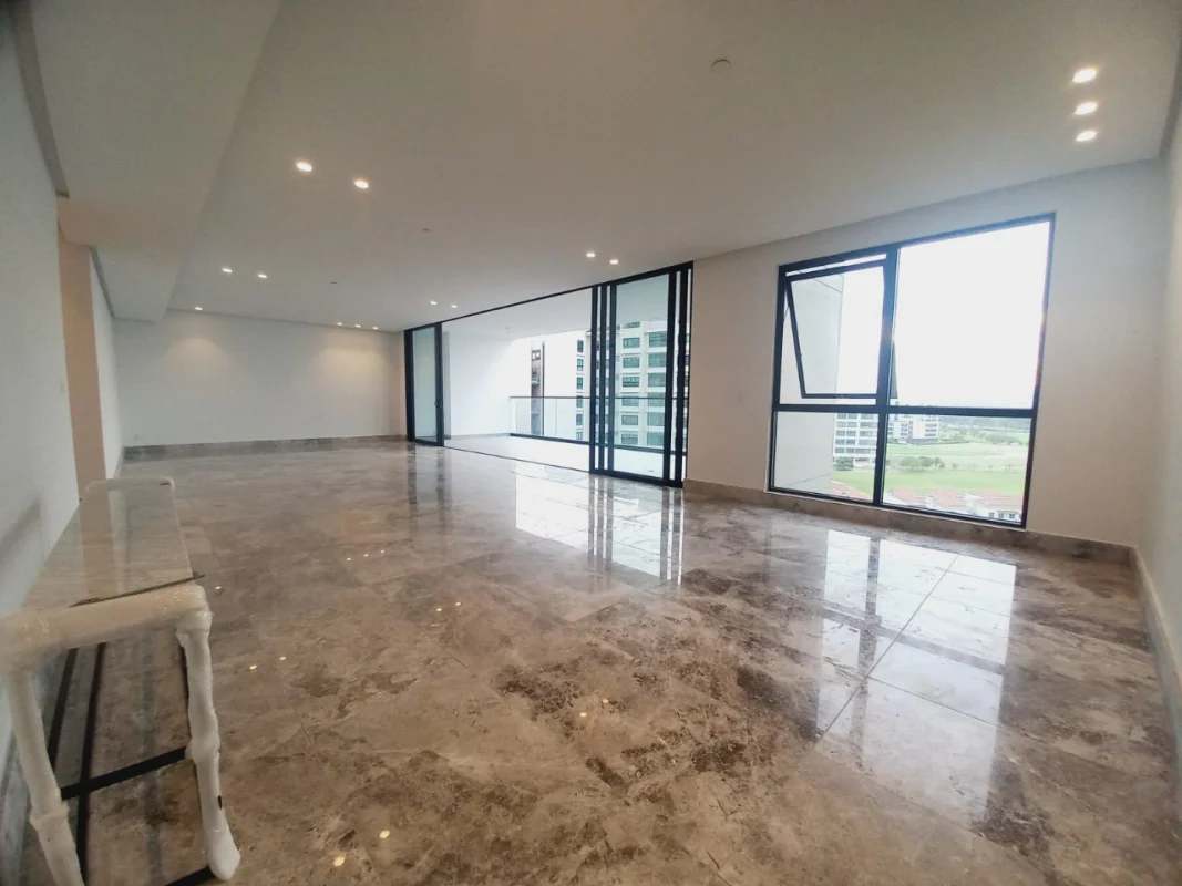 Bright open living area with marble floors and access to panoramic balcony at PH Empire Residences Panama