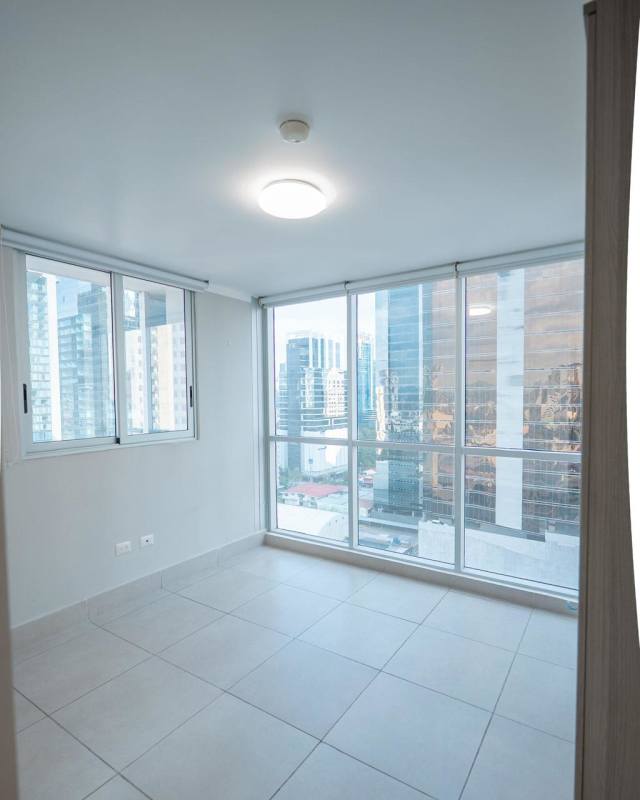 Bright living room with large windows and ceramic floors at PH Park City Obarrio Panama
