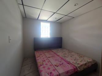 Bedroom with bed, closet and window grilles in affordable home Panama Oeste