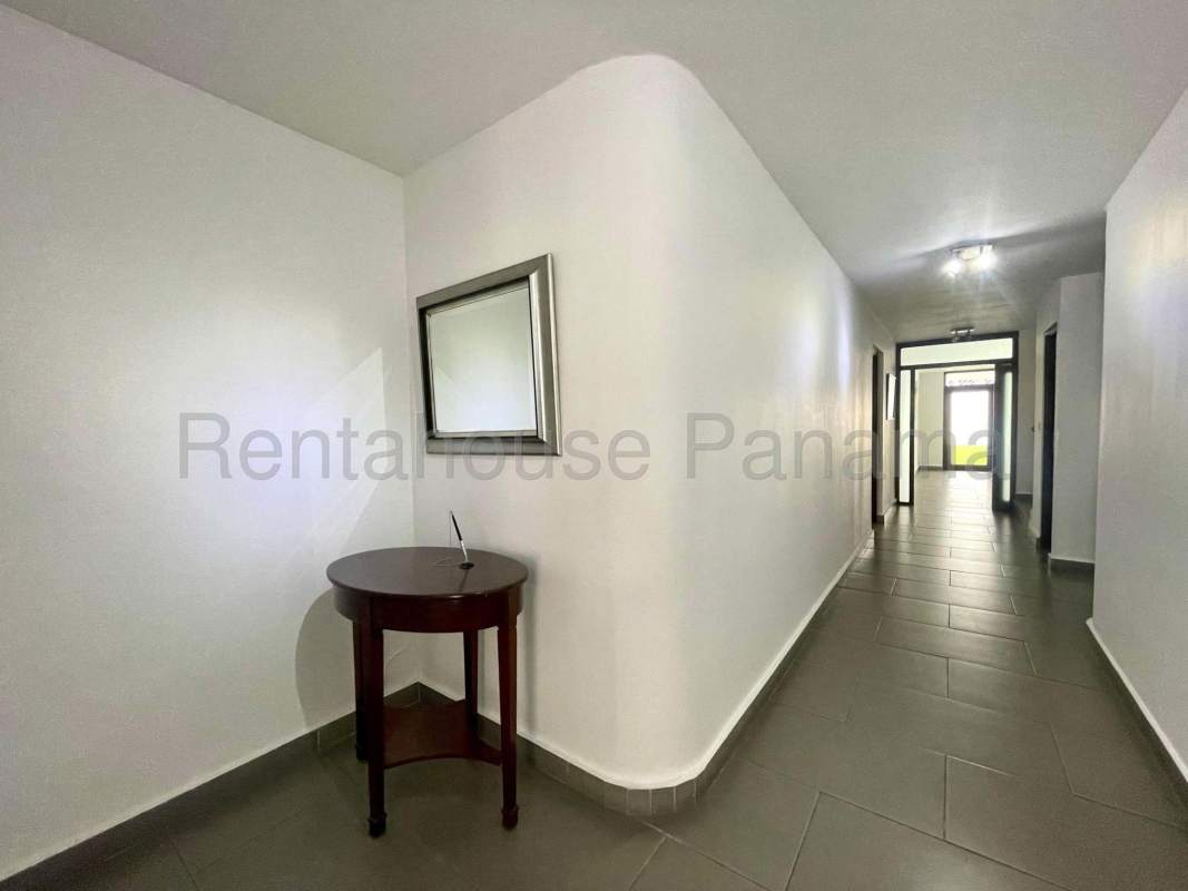 Conference room with glass table, black chairs, and bright lighting in Obarrio house for rent