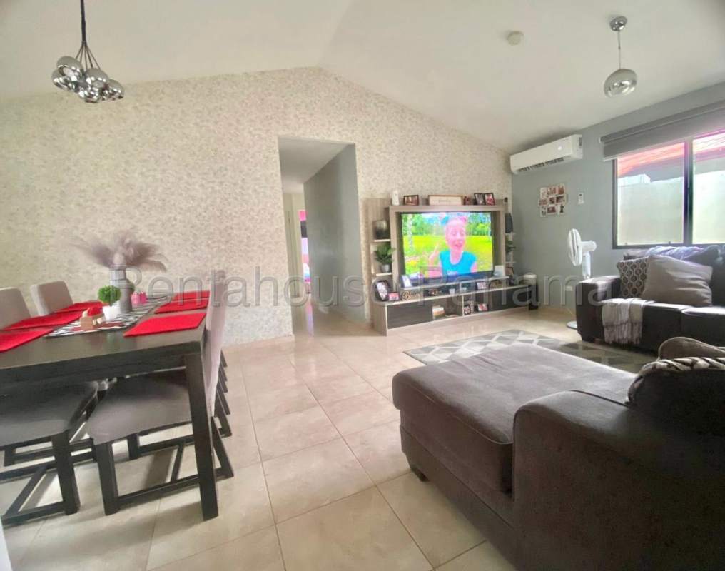 Open plan living dining room with sectional sofa, dining table, AC, vaulted ceiling in PH Vistas del Lago Las Cumbres