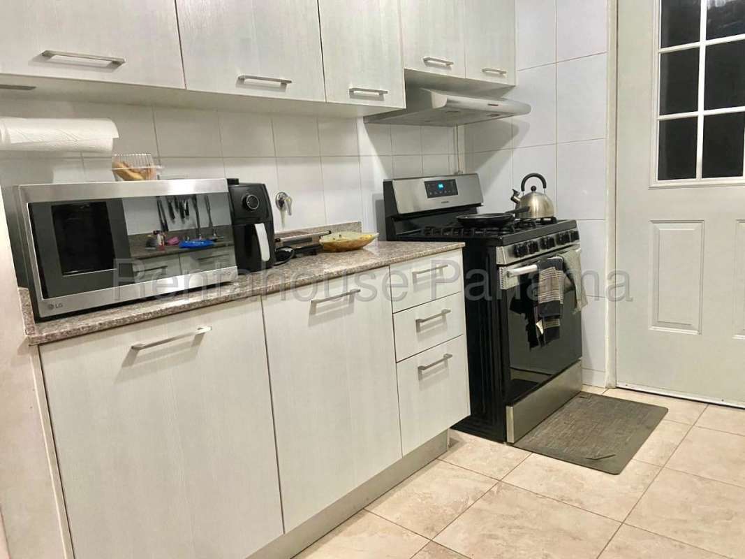 Modern kitchen with light cabinets, gas stove, microwave PH Vistas del Lago Las Cumbres