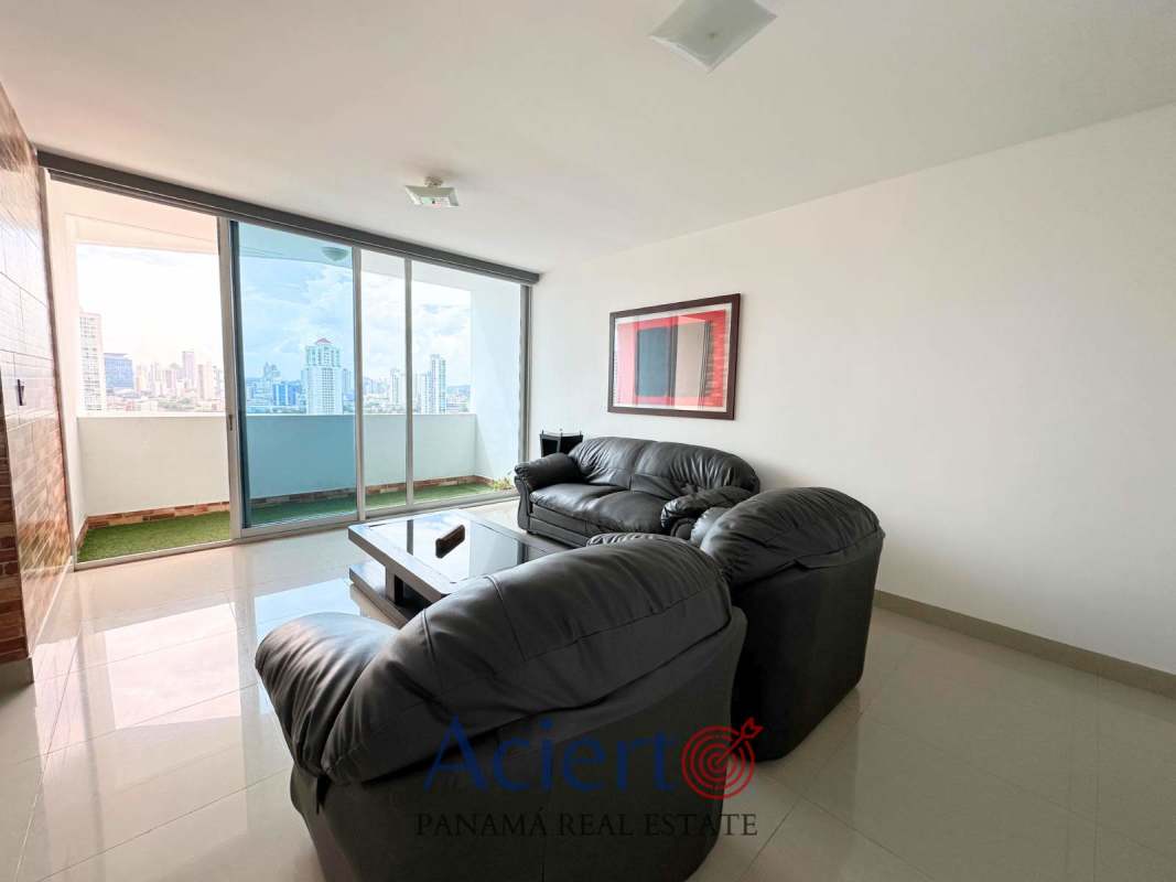 Living area with black leather sofas, large windows to balcony, city skyline in PH San Francisco