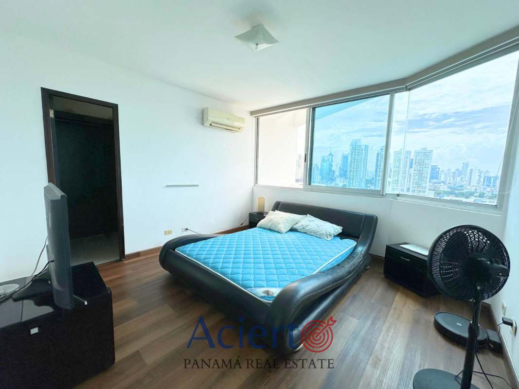 Bedroom with large windows overlooking Panama City skyline in PH San Francisco