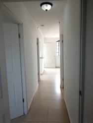 Basic kitchen with white cabinets and granite top Villa de Santander Panama