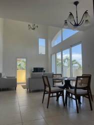 Open dining and living with double height windows and ceramic floors in PH El Tucán