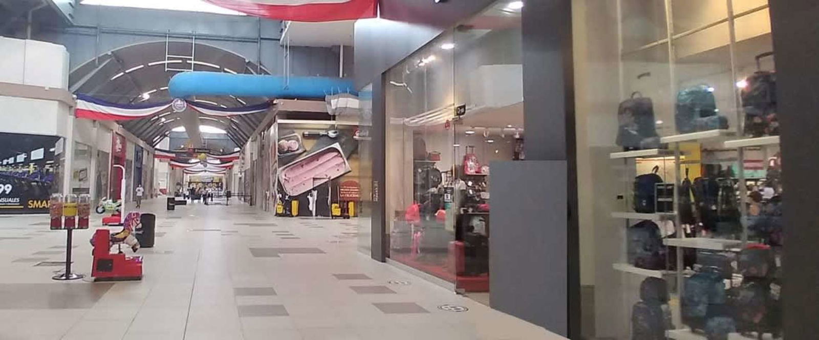 Wide corridor view with commercial stores inside Mega Mall Tocumen Panama