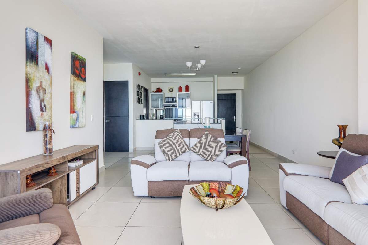 Spacious living room with natural light and sea view balcony at PH Destiny Avenida Balboa