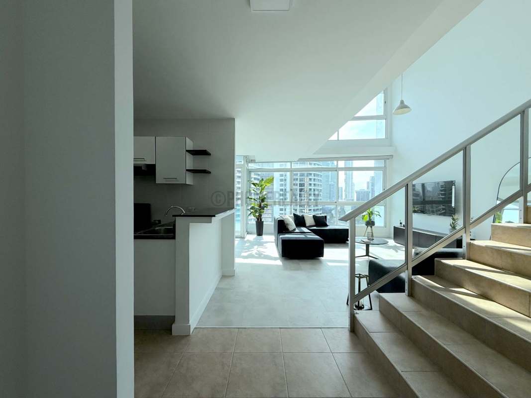 Kitchen with granite countertops, modern appliances, and ocean backdrop at PH BICSA Tower Panama City