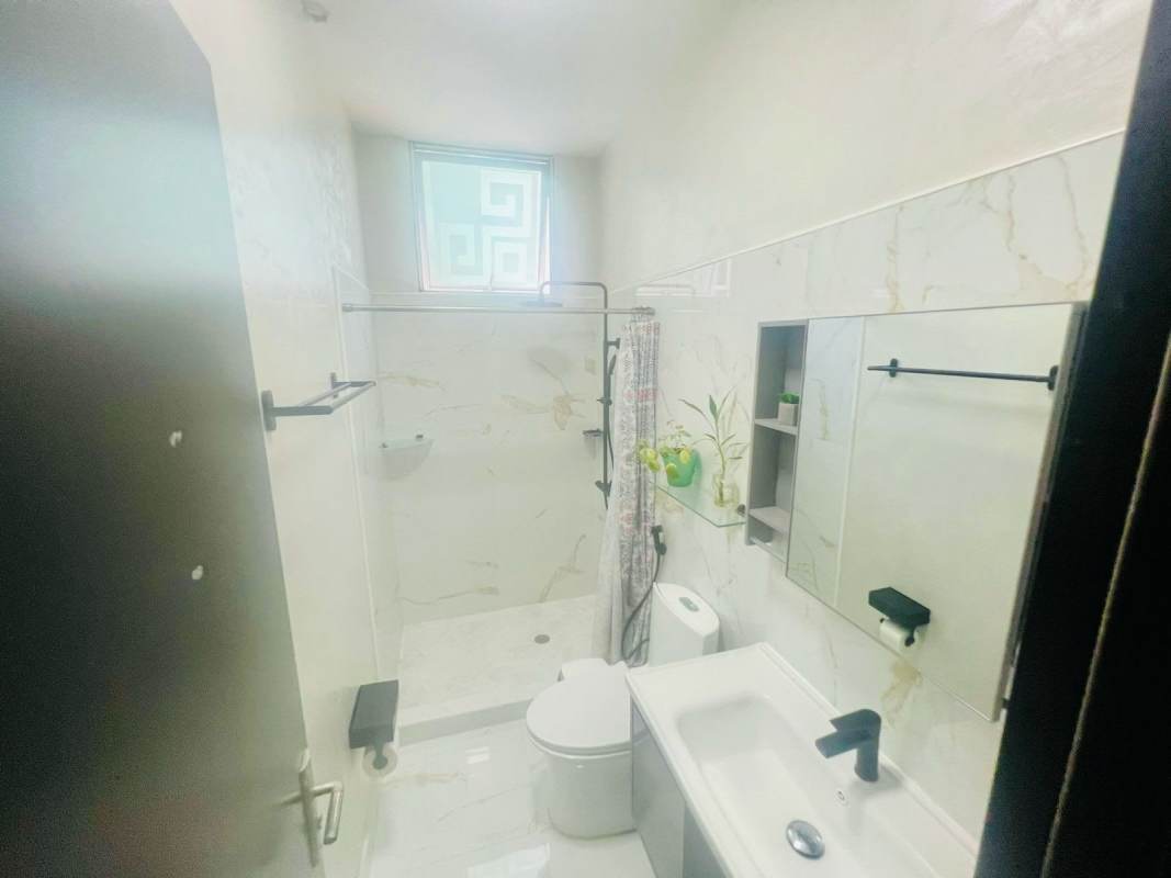 Modern bathroom with glass shower and granite vanity in PH Coral Tower for sale