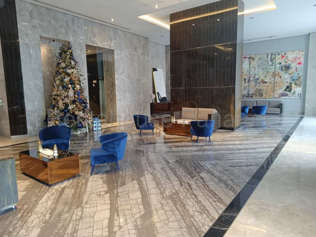 Modern gourmet kitchen with island, stainless steel appliances Empire Residences Santa Maria