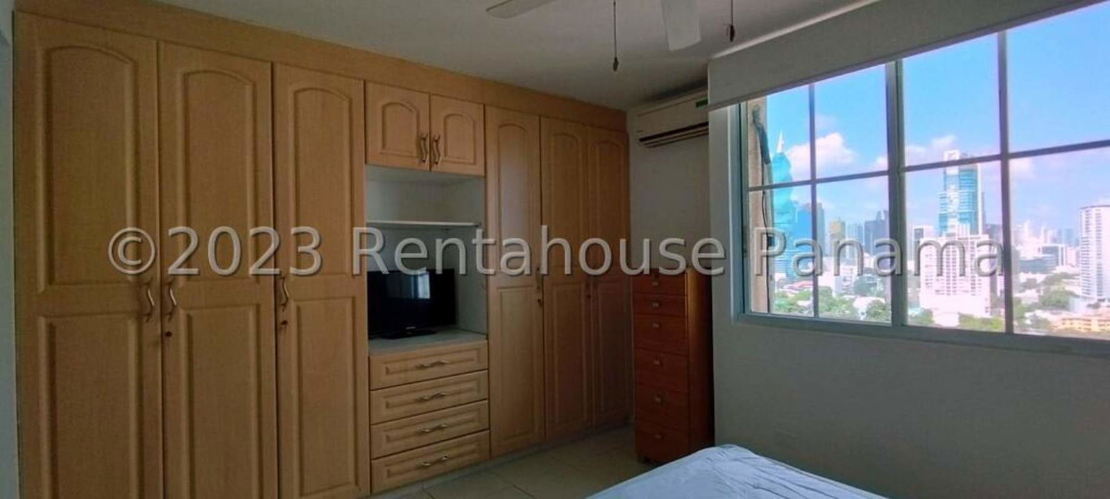 Bedroom with built-in wooden wardrobe, AC, city view window in PH Costa Pacifica Punta Pacifica Panama