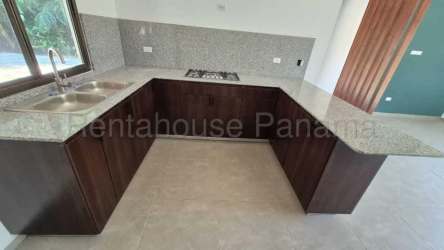New kitchen with granite counters and large window in modern house Villa Guadalupe David Panama