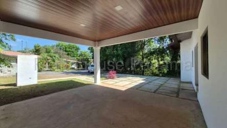 Covered carport with paved driveway in modern Villa Guadalupe house David Panama