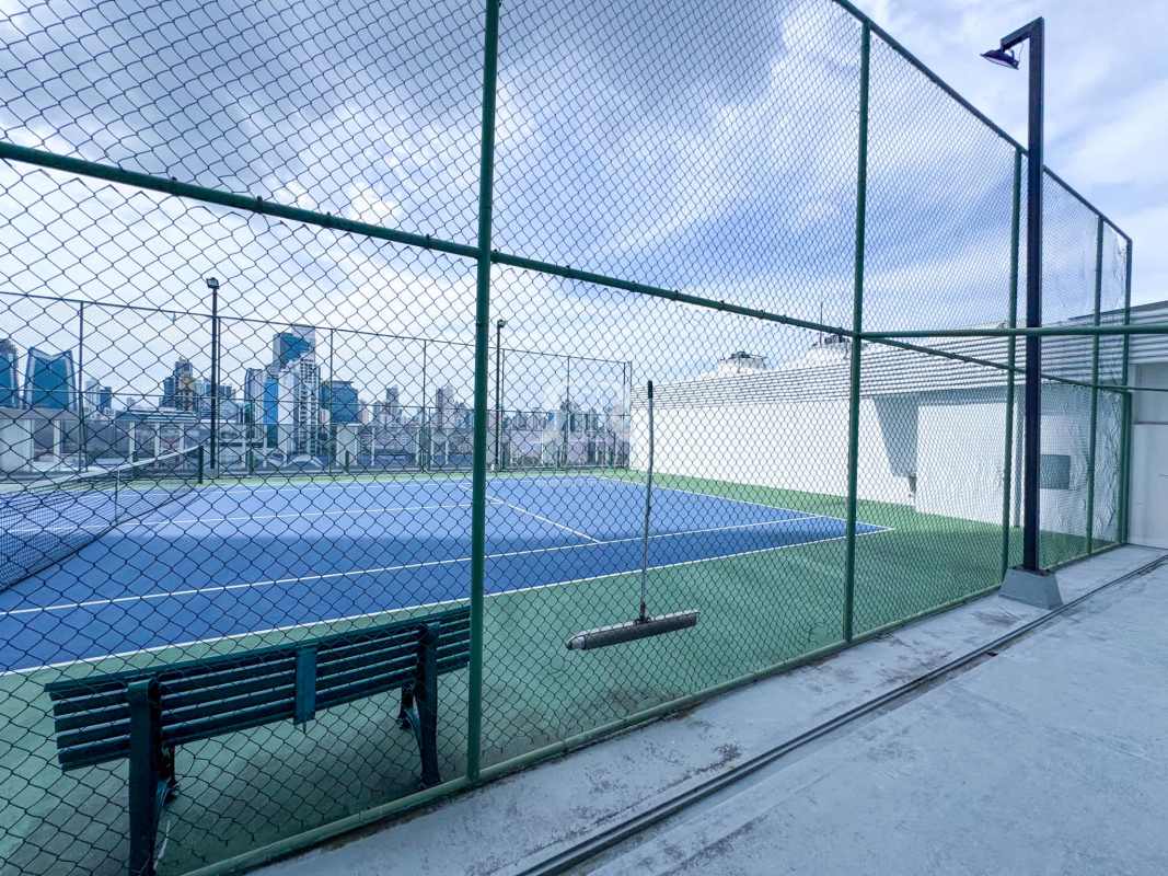 Glass door indoor squash court with hardwood floors at PH The Towers Panama