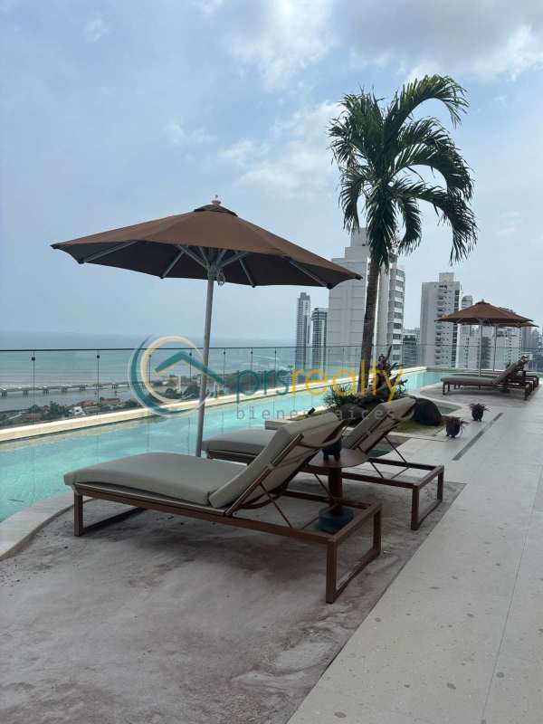 Infinity pool and lounge area overlooking ocean and skyline at PH Dovle Coco del Mar Panama