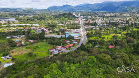 Town layout with main road, houses, greenery surrounded by mountains near prime development land in Volcán Panama