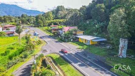 Roadside land aerial with nearby buildings mountain backdrop Volcán Panama