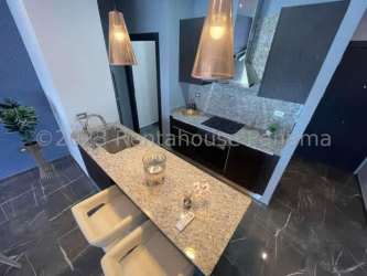 Kitchen with granite countertop, pendant lighting, modern cabinetry in Santa Cruz Tower David Panama
