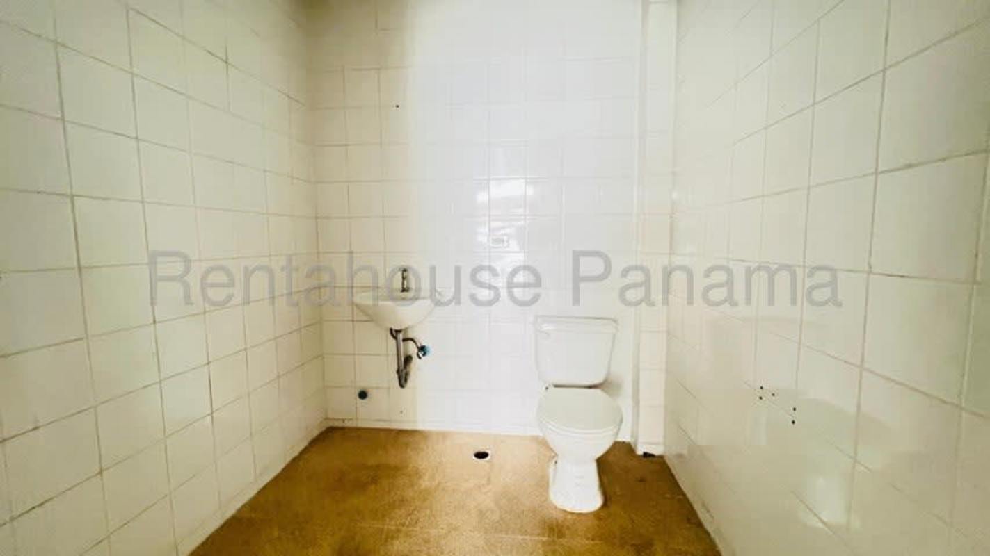 Minimalist tiled bathroom with toilet and sink in commercial unit Costa del Este Panama
