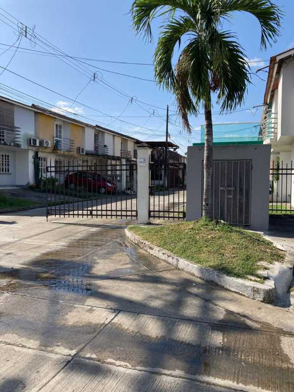 Gated townhouse complex entrance with palm tree and lawn PH Mirador del Bosque Panama