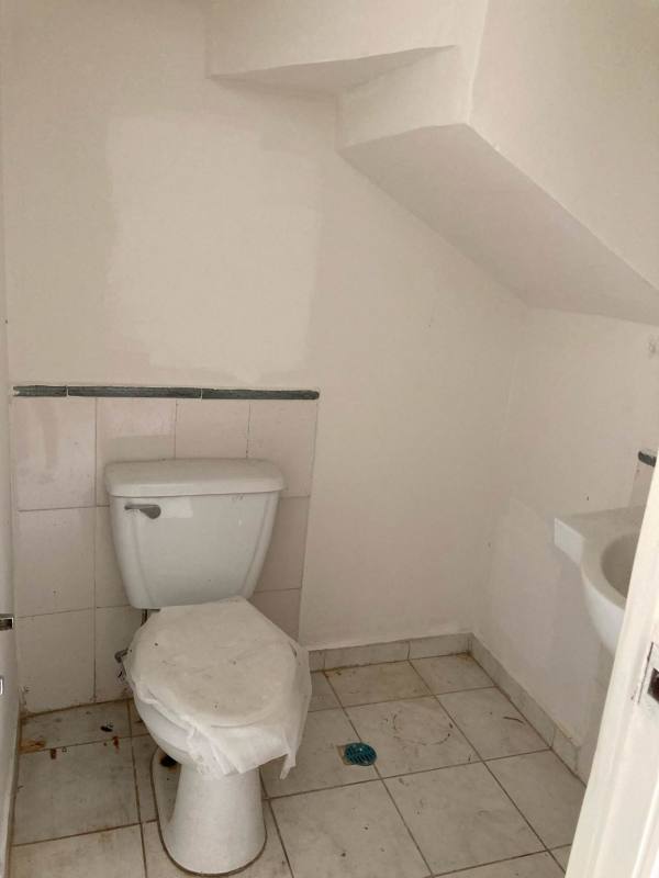 Compact half bathroom under stairs with sink and toilet PH Mirador del Bosque Panama