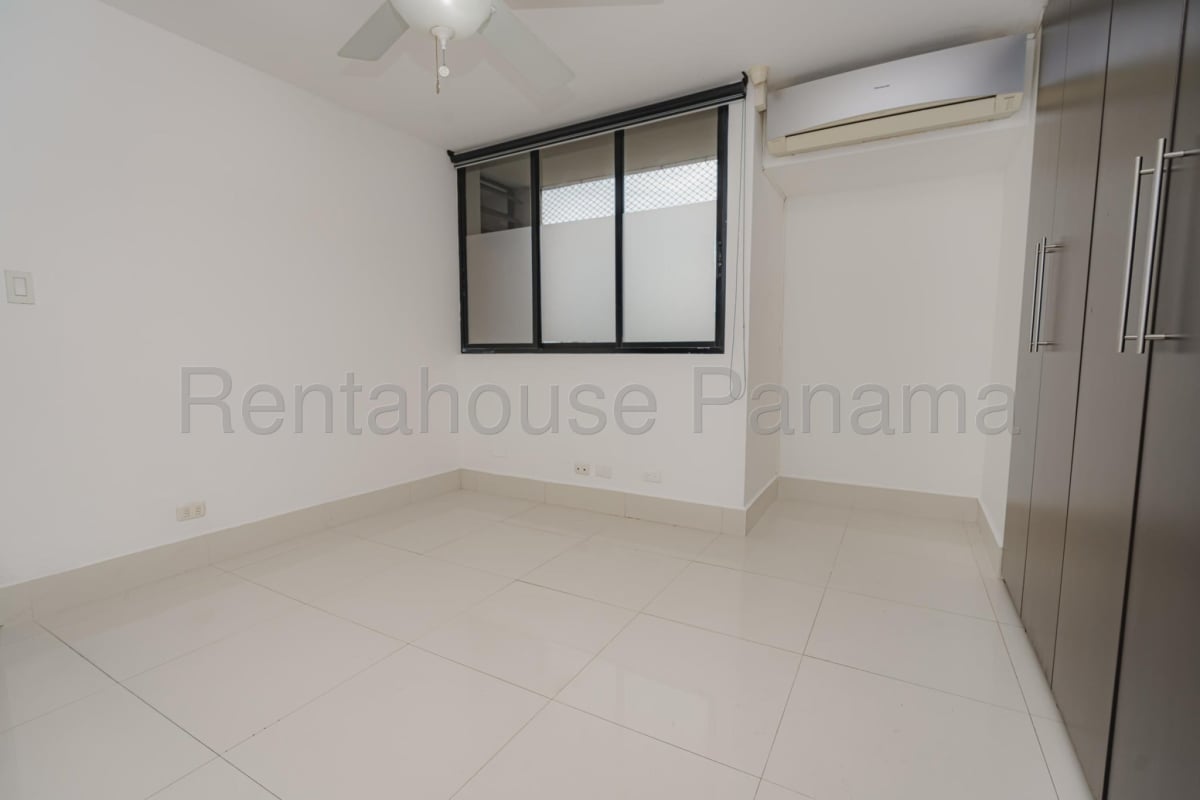 Spacious modern kitchen with granite surfaces, island and wood cabinetry in San Francisco Panama