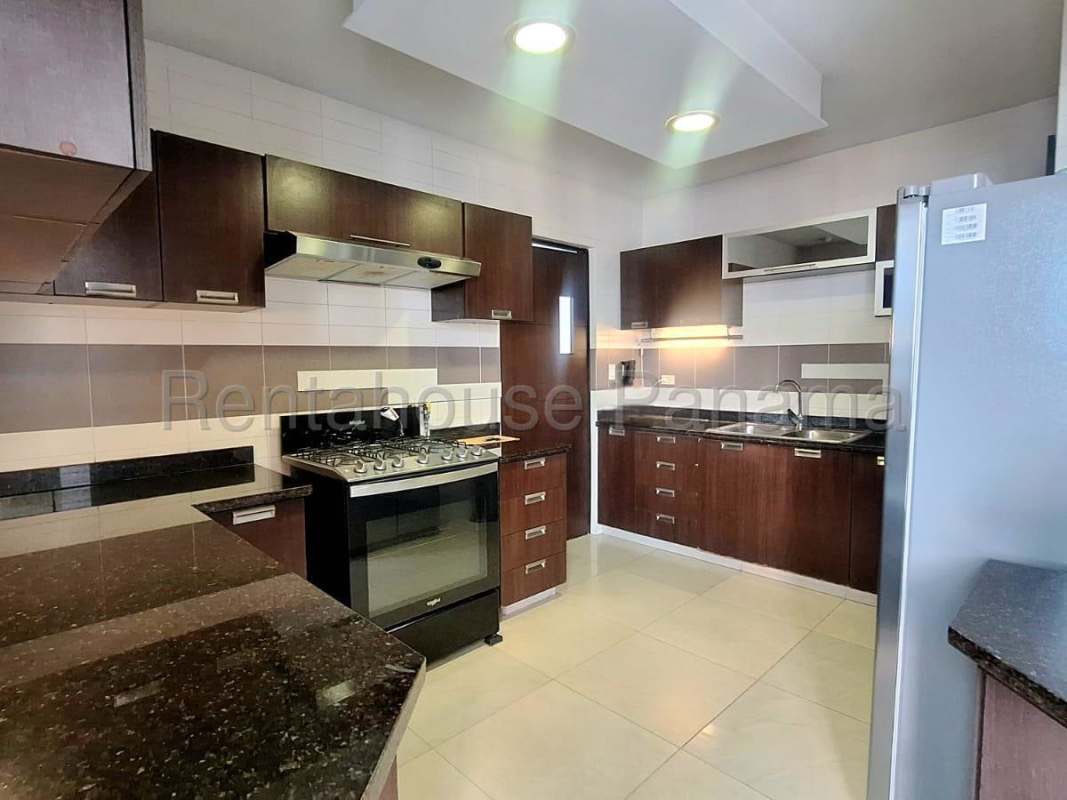 Contemporary kitchen featuring granite countertops, dark wood cabinetry, and stainless steel appliances PH San Francisco Bay Tower Panama
