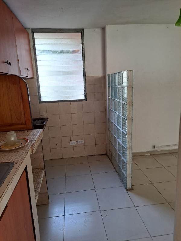 Bedroom with white tile floors and closet area in budget apartment for sale near 12 de Octubre Panama
