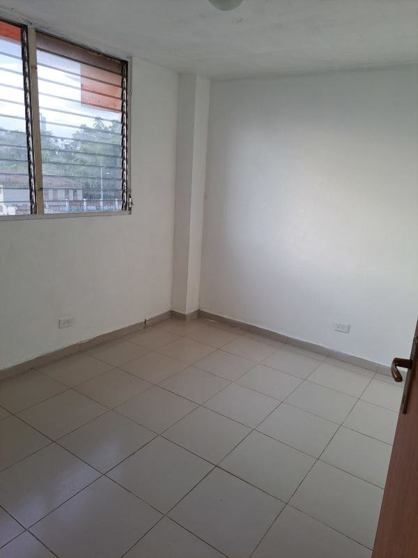 Empty bedroom with window and white ceramic tiles in affordable 3 bedroom condo for sale Panama City