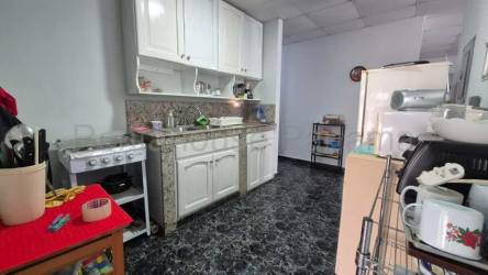 Traditional kitchen with granite countertop, gas stove and cabinetry in David Panama