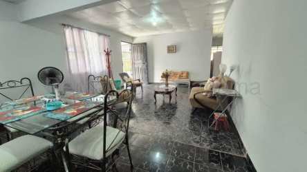 Open-plan living and dining room with tiled floor and natural light in David Chiriquí