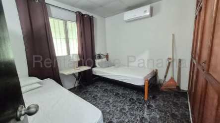 Simple bedroom with two beds, split AC, desk and wardrobe for sale in David Panama
